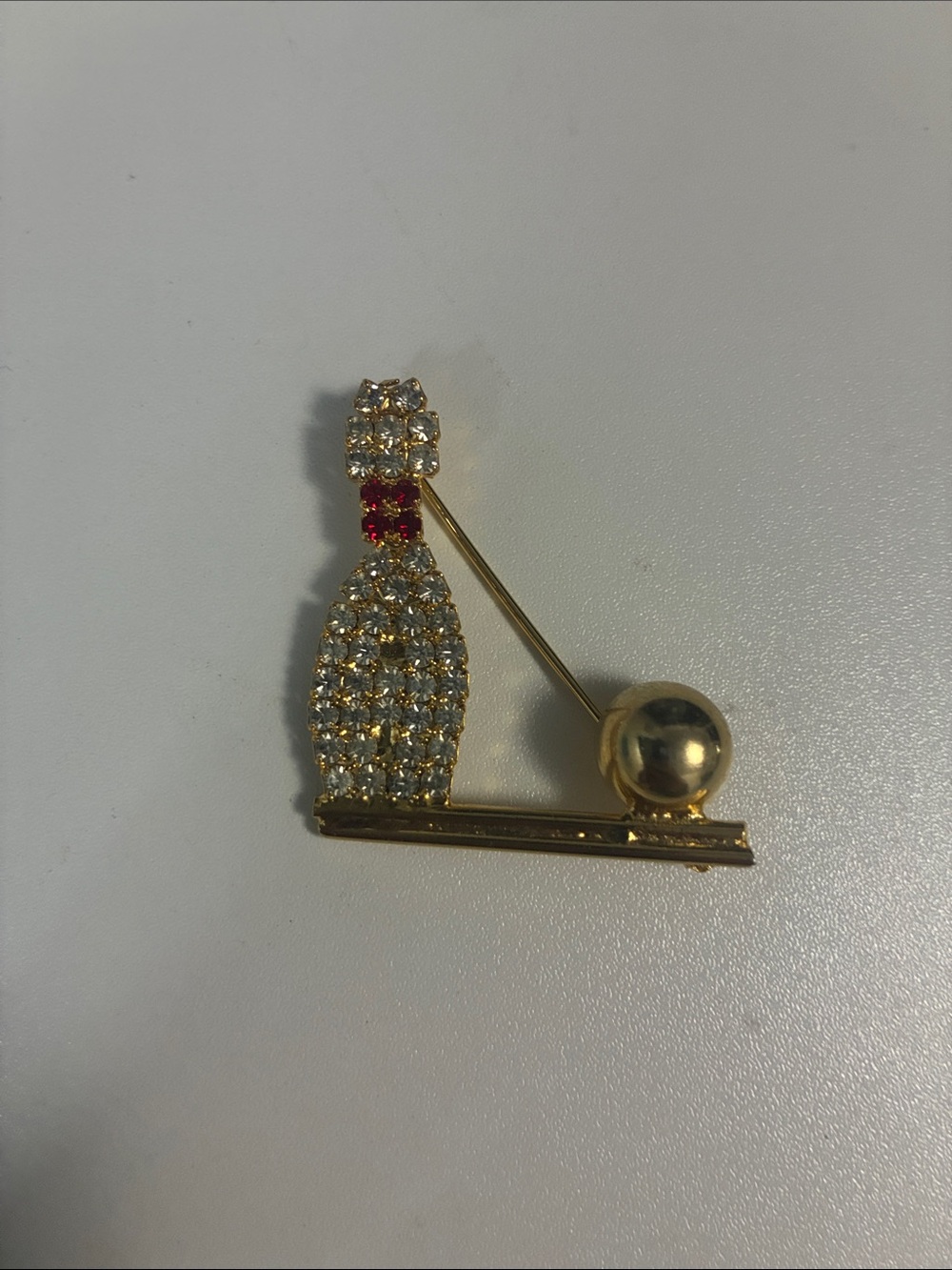 Vintage gold tone rhinestone bowling ball and pin brooch